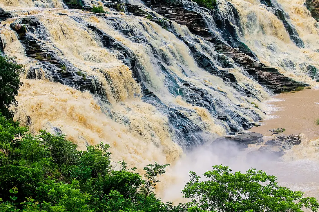 A beautiful view of the Gurara Waterfalls with lush green vegetation 02