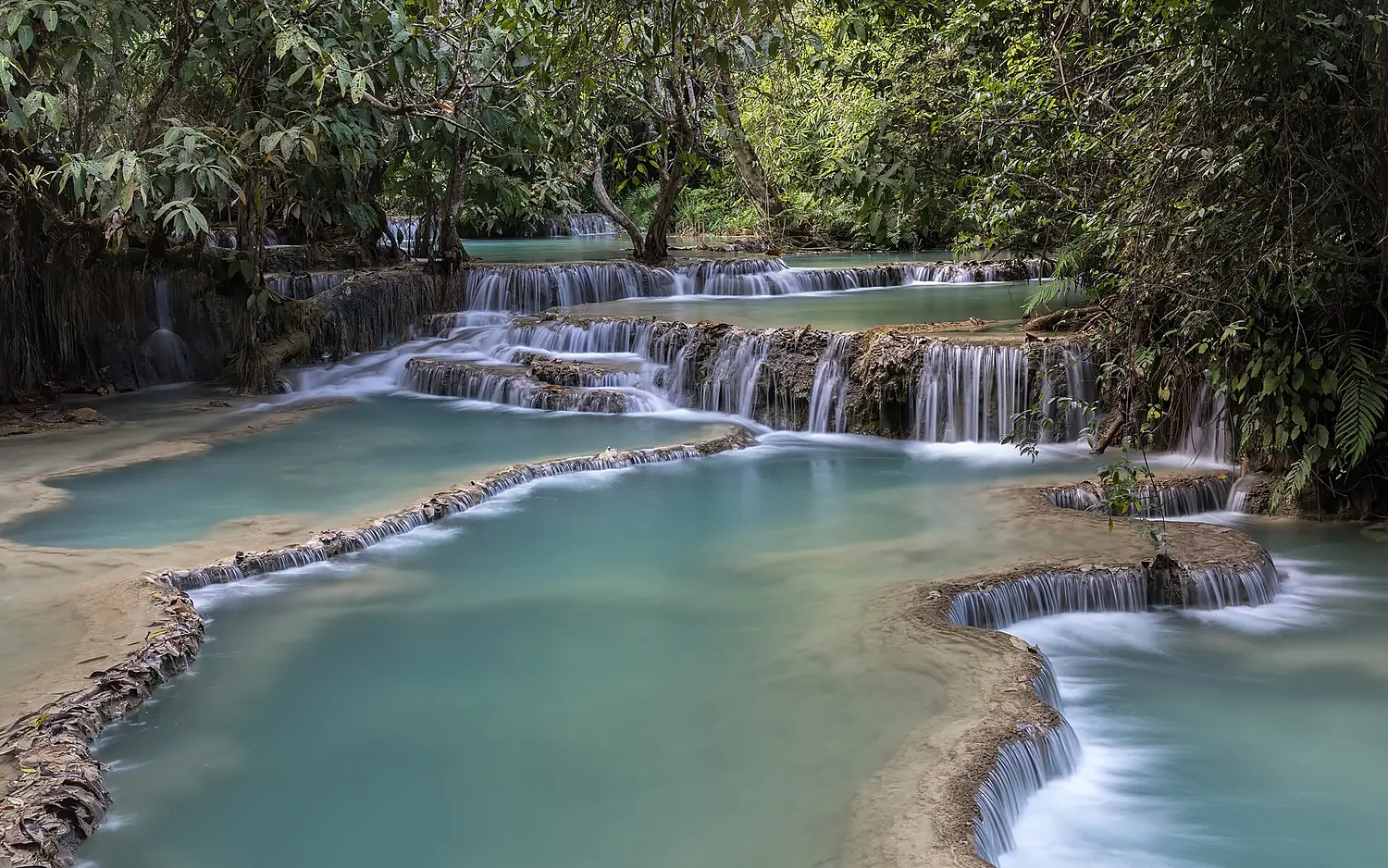 Kuang Si Falls and its turquoise tiered water pools in Luang Prabang province Laos